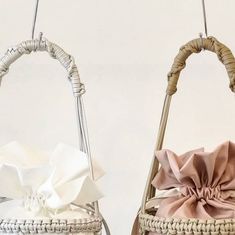 two baskets with bows hanging from the handles