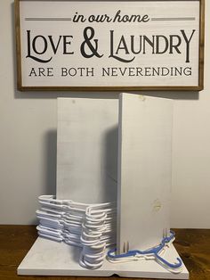 there is a sign that says in our home love and laundry are both neverending