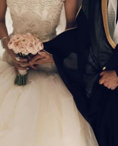 a bride and groom standing next to each other