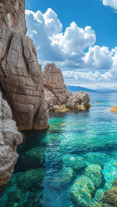 the water is crystal blue and clear with rocks on both sides that are covered in green algae