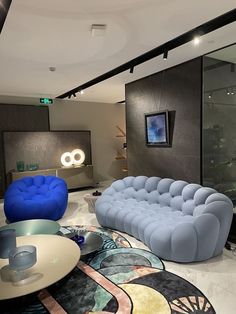 a living room filled with lots of furniture next to a wall mounted clock on the wall