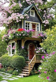 a house with flowers on the roof and stairs leading up to it's second story