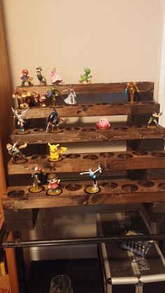 the shelves are made out of wooden pallets and have figurines on them