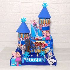 this is an image of a frozen princess birthday cake with toys and decorations on it