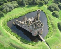 an aerial view of a castle surrounded by green grass