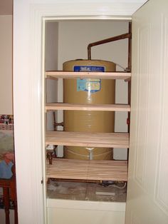 an open closet with shelves and a large container