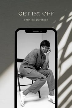 a woman sitting on a chair in front of a cell phone with the caption get 15 % off your first purchase