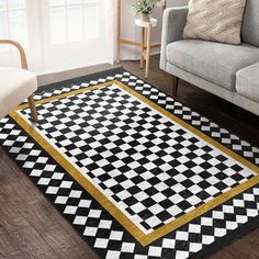 a black and white checkered rug with gold trim on the floor in a living room