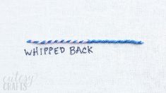 the back side of a white shirt with blue thread on it and an embroidered message that reads whipped back