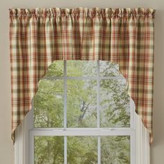 a window with a plaid curtain hanging on it's side