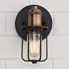 an outdoor light fixture mounted on a white brick wall