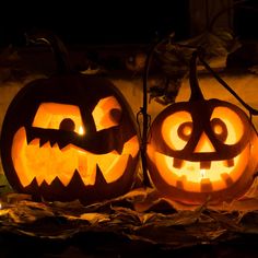 two carved jack o lantern pumpkins sitting next to each other