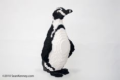 a penguin made out of legos on a white background