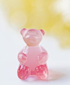 a pink teddy bear sitting on top of a white table