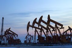 oil pumps in the middle of nowhere at sunset royalty images, stock photos and illustrations