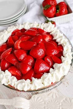 a pie with strawberries in it on a table