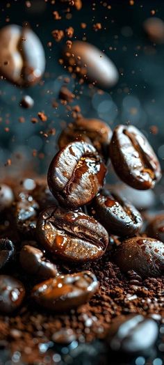 some coffee beans are falling into the air and on top of it is water droplets