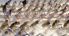 a large group of people riding skis on top of water