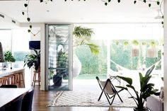 a living room filled with furniture and plants