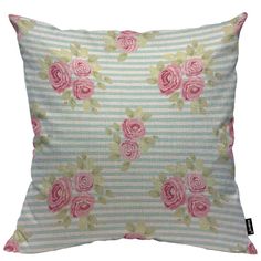 a pillow with pink roses on the front and green stripes in the back, sitting on a white surface