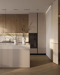 a modern kitchen with white marble counter tops and wooden cabinetry, along with an island in the middle