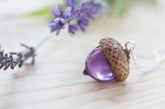 "A beautiful acorn necklace, in a gorgeous range of colours - the very most magical Wendy's kiss. The acorn is sculpted from a real acorn, and is capped with a real acorn cap, foraged from the base of a huge, friendly Oak tree. The actual acorn is made of UV stable jewellery-grade resin, so it is lightweight, but hardy. The acorn itself is 25mm across, and comes on an 18\" sterling silver chain. Longer chains are available here, if you like wearing your necklaces lower: https://www.etsy.com/uk/l Acorn Jewelry, Floating Diamond Necklace, Acorn Pendant, Acorn Necklace, Real Flower Jewelry, Necklace Purple, Jewelry Resin, Purple Necklace, Pink Necklace