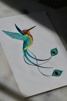 a drawing of a colorful bird on paper