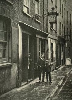 two men are standing in the doorway of an old building