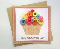 a birthday card with buttons in a cupcake