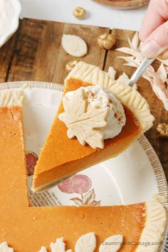 a slice of pumpkin pie on a white plate with a fork in it and the rest of the pie being eaten