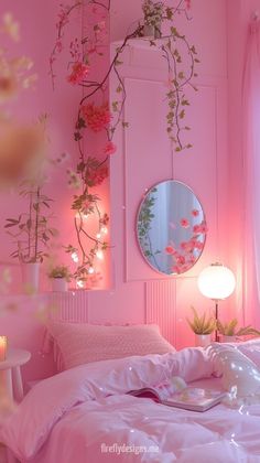 a bedroom with pink walls and flowers hanging from the ceiling, along with a mirror