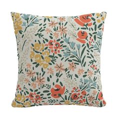 an orange and blue flowered pillow on a white background, with green leaves and flowers