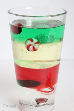 a shot glass filled with liquid and candy canes