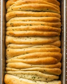 a loaf of garlic bread in a baking pan with lots of crusts on top