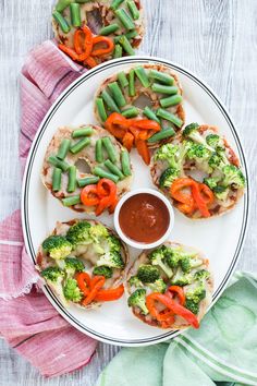 broccoli, carrots and green beans are arranged on a plate with sauce