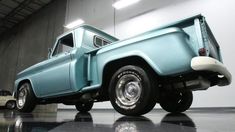 an old pick up truck parked in a garage