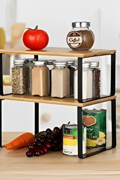 three tiered spice rack with spices and fruit on top, sitting on a wooden table