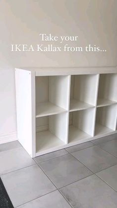 a white book shelf sitting on top of a tiled floor next to a sign that says, take your ikea kallax from this