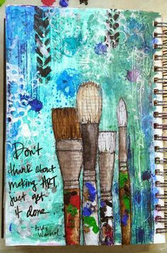 an art journal with three brushes on it