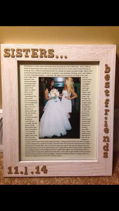 a wedding picture frame with the words sisters and two women in white dresses on it