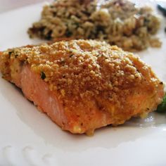 a piece of salmon on a white plate with broccoli and other food items