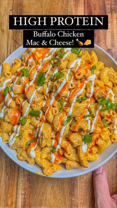 a white plate topped with macaroni and cheese covered in ranch dressing next to a hand holding a fork