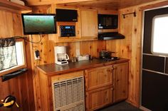 a kitchen area with wood paneling and appliances