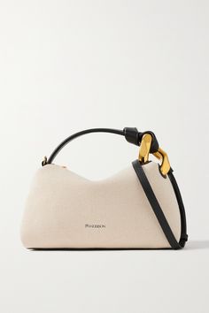 Fans of JW Anderson will instantly recognize this bag by its chunky chain embellishment - the detail has adorned everything from the brand's shoes to its tailoring. Made from cream canvas, it has a slouchy shape with plenty of space inside for your phone, wallet and cosmetics. Carry yours by the black leather top handle or adjustable shoulder strap. Tas Bahu, Pretty Bags