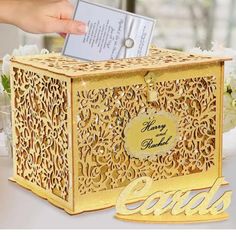 a person holding a card in a decorative box