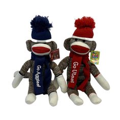 two sock monkeys wearing hats and scarves