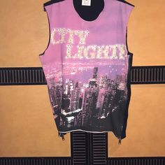 Authentic D&G Brand Top, 100% Cotton With Crystals Embellished On The “City Lights” Imprint. The Back Is Black With A Purple Logo At The Neckline. Has Side Zippers With The Logo On The Zipper Pulls. Purple Sleeveless Top For Night Out, Sleeveless Purple Top For Night Out, Purple Graphic Print Sleeveless Tops, Purple Sleeveless Graphic Print Top, Purple Sleeveless Top With Graphic Print, Pink Sleeveless Top For Streetwear, Trendy Purple Tank Top, Purple Sleeveless Tank Top For Night Out, Pink Sleeveless Blouse For Night Out