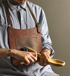 a man is holding two bananas in one hand and a pair of scissors in the other