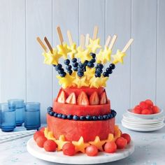 a cake decorated with stars and berries on a table