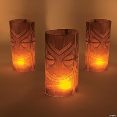 three tiki glasses are lit up in the dark for $ 6 8 each or more